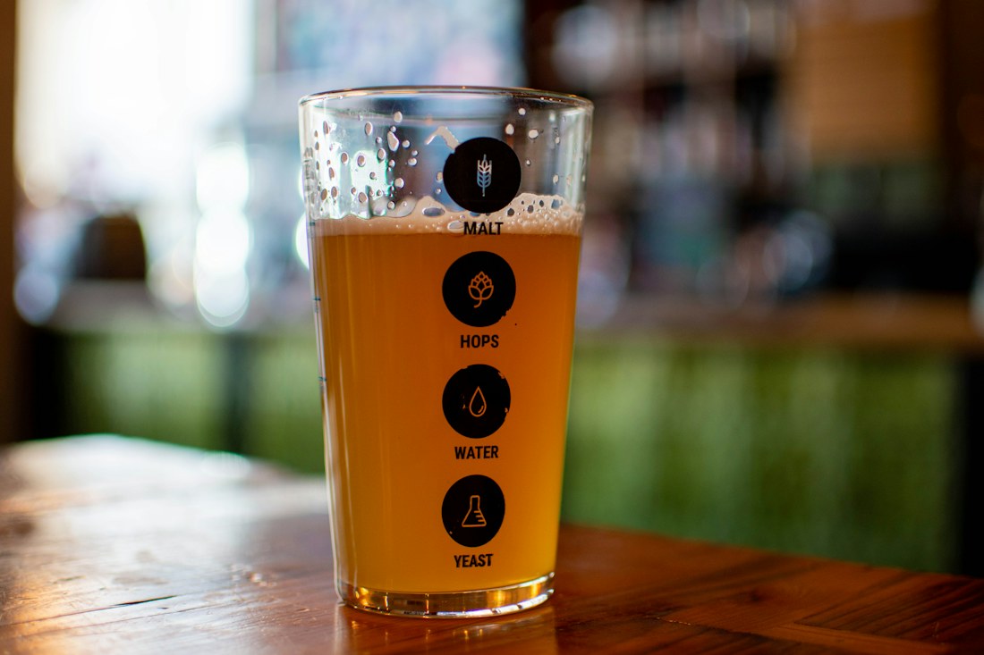 Golden pint of ale on a traditional wooden pub table
